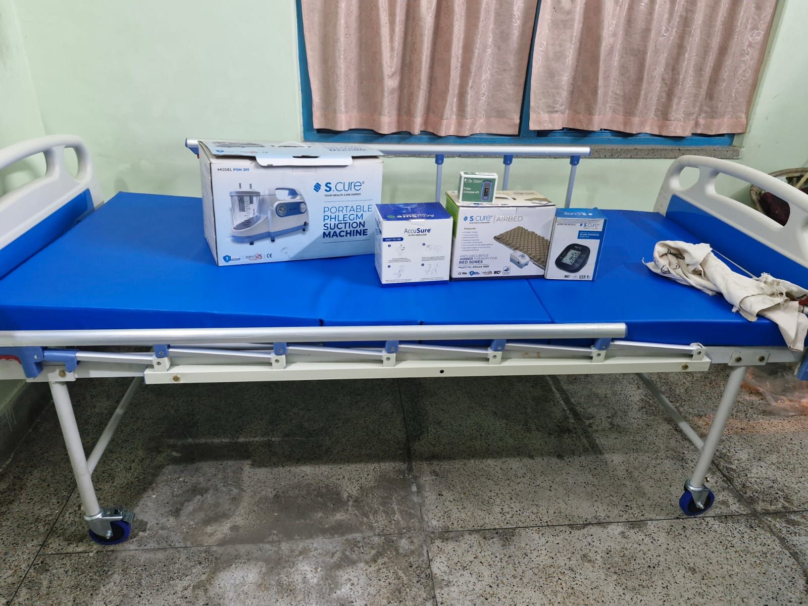 Hospital bed with medical equipment on a concrete floor